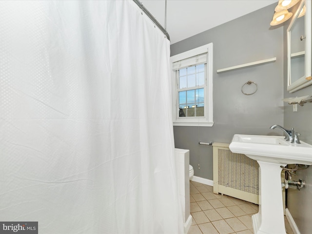 bathroom featuring tile patterned flooring and toilet