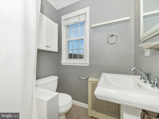 bathroom featuring tile patterned floors, toilet, and sink