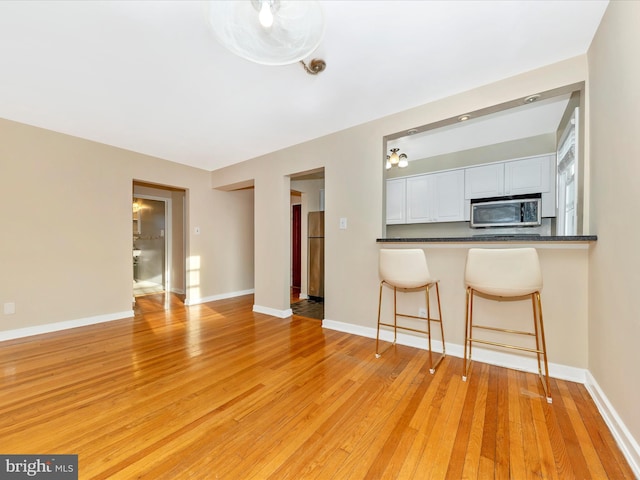 unfurnished living room with light hardwood / wood-style flooring