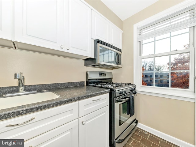 kitchen with white cabinets, stainless steel appliances, and sink