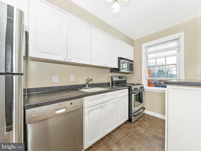 kitchen featuring sink, white cabinets, and stainless steel appliances