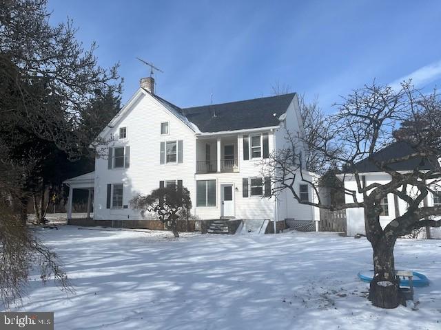 snow covered property featuring a balcony