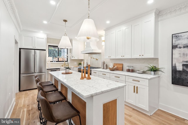 kitchen with custom exhaust hood, white cabinetry, and stainless steel appliances