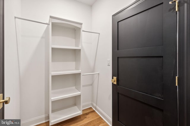 walk in closet featuring hardwood / wood-style flooring