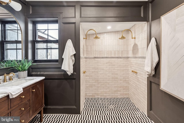 bathroom featuring vanity and tiled shower