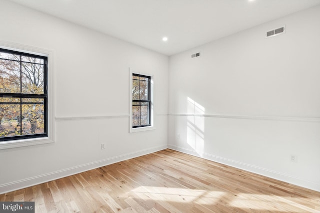 empty room with light hardwood / wood-style flooring