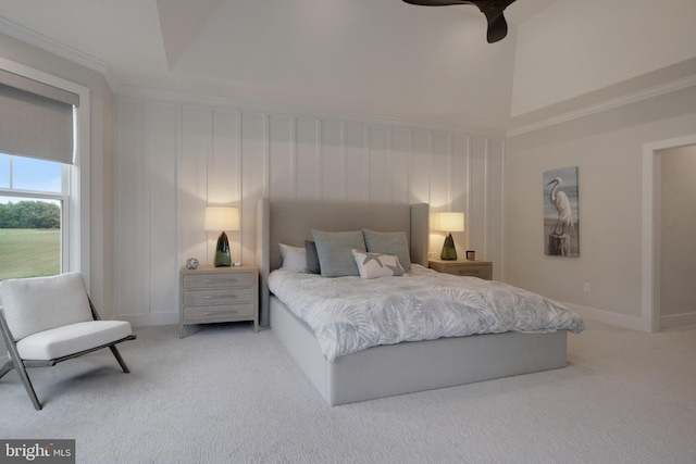 bedroom with ceiling fan, carpet, and a high ceiling