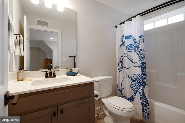 full bathroom with shower / tub combo, vanity, and toilet