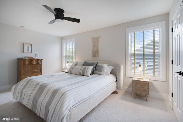 bedroom with light carpet and ceiling fan