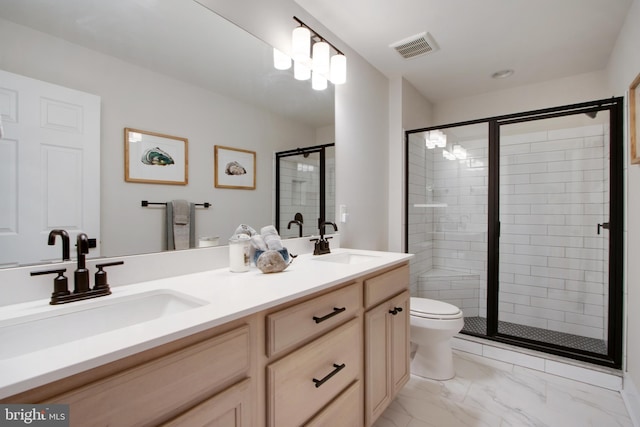 bathroom with a shower with door, vanity, and toilet