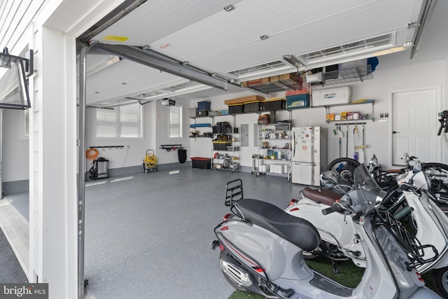 garage featuring a garage door opener and white fridge