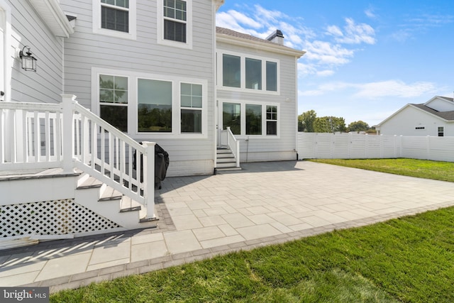 back of house with a yard and a patio