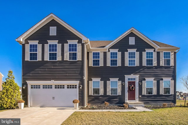 view of front of property featuring a garage and a front yard