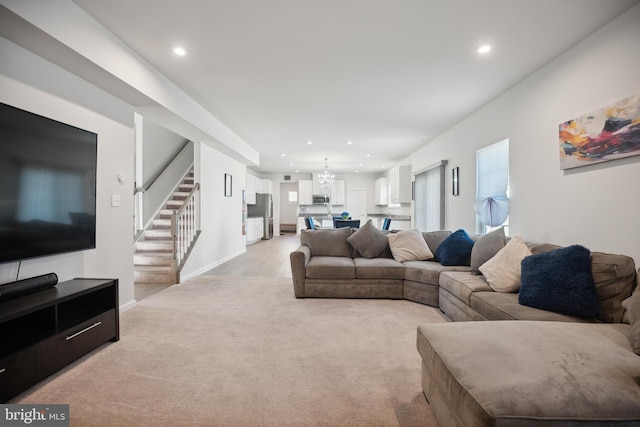 living room featuring a chandelier and light colored carpet