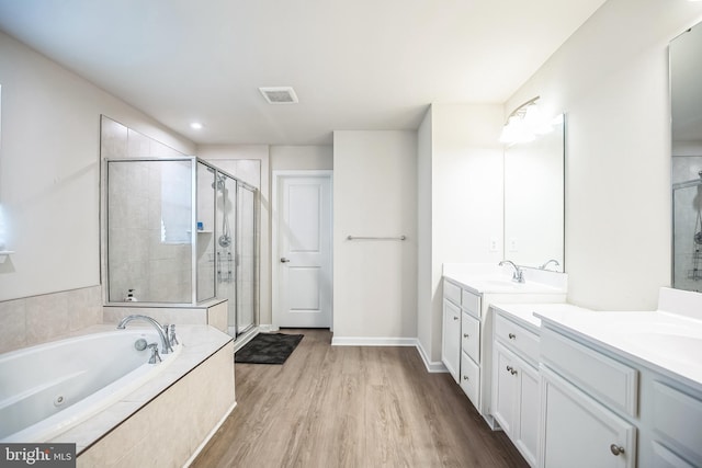 bathroom with vanity, shower with separate bathtub, and hardwood / wood-style flooring