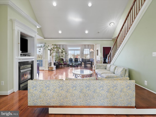 living room featuring high vaulted ceiling and hardwood / wood-style floors