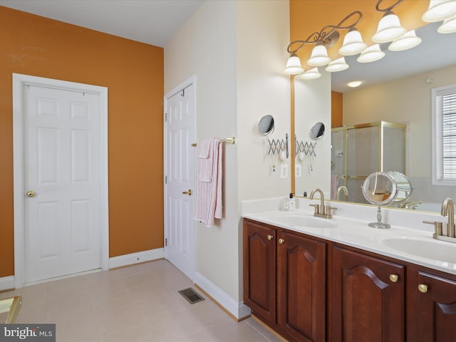 bathroom featuring walk in shower, vanity, and tile patterned flooring