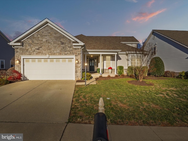 view of front of property with a garage and a yard