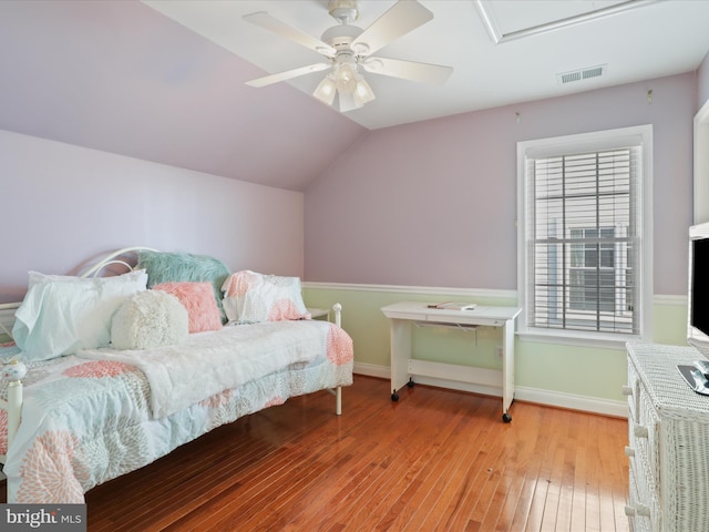 bedroom featuring light hardwood / wood-style flooring, vaulted ceiling, and ceiling fan