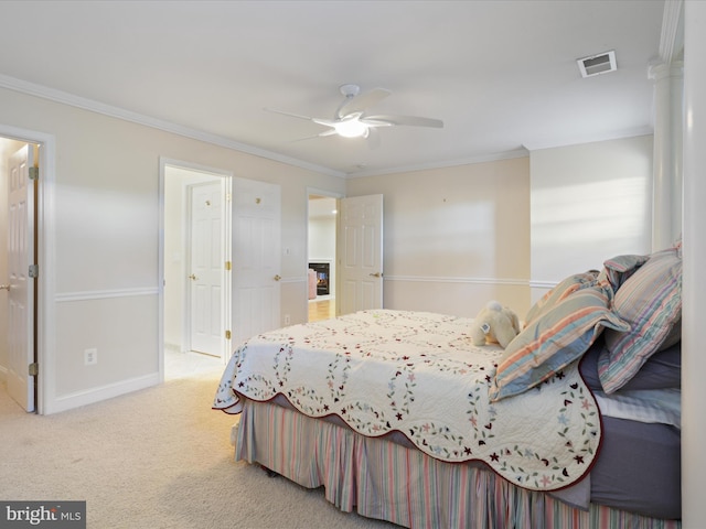 carpeted bedroom with crown molding and ceiling fan