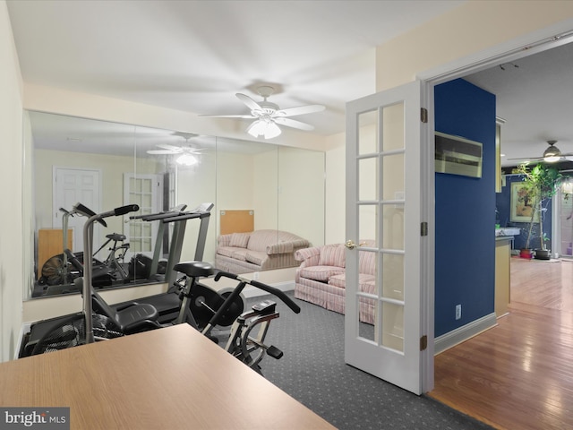 exercise room featuring wood-type flooring, french doors, and ceiling fan