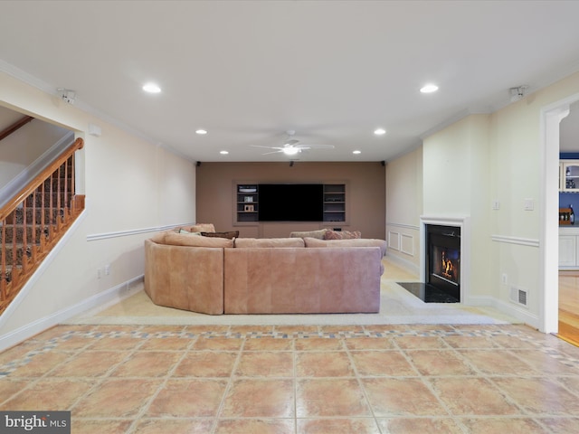 living room with crown molding, built in shelves, ceiling fan, and light tile patterned flooring