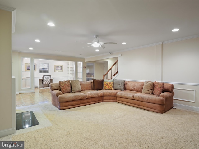 carpeted living room featuring crown molding and ceiling fan