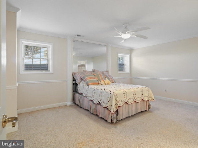 carpeted bedroom featuring ceiling fan, ornamental molding, and multiple windows