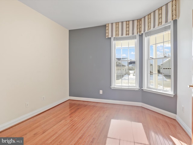 unfurnished room with light wood-type flooring