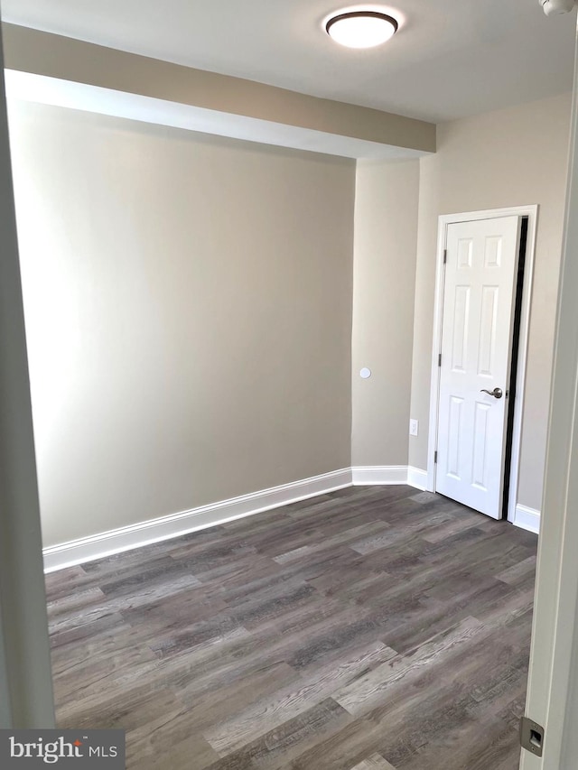 unfurnished room featuring dark hardwood / wood-style flooring