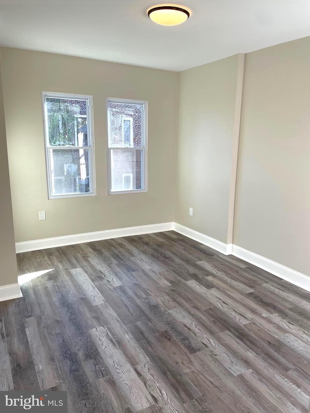 spare room featuring dark hardwood / wood-style flooring