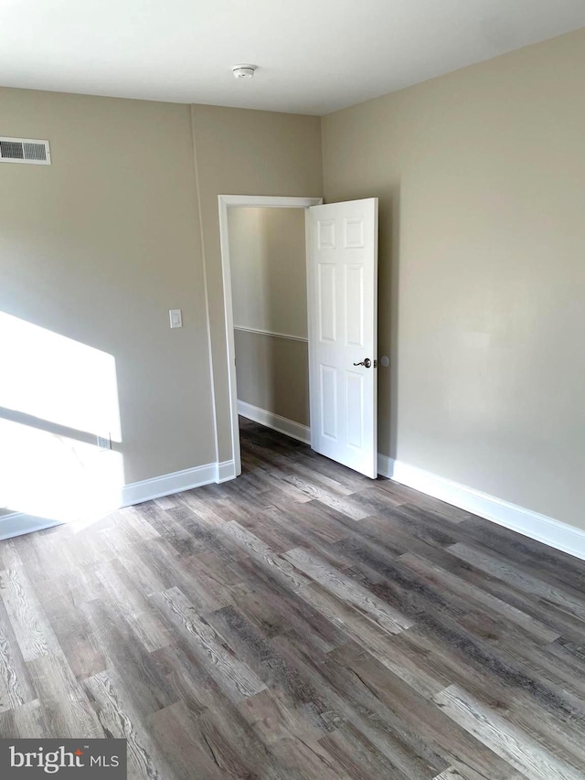 spare room featuring dark hardwood / wood-style flooring