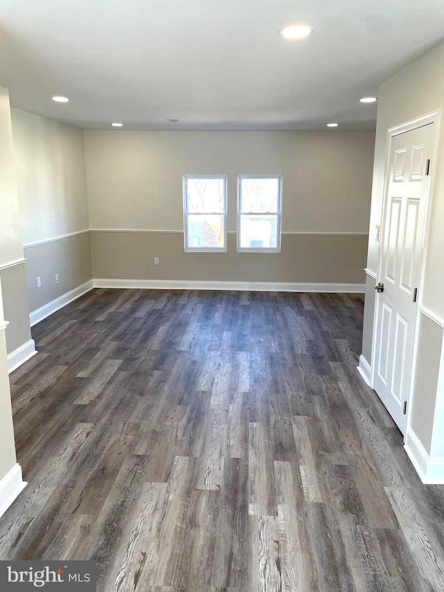 spare room with dark hardwood / wood-style flooring