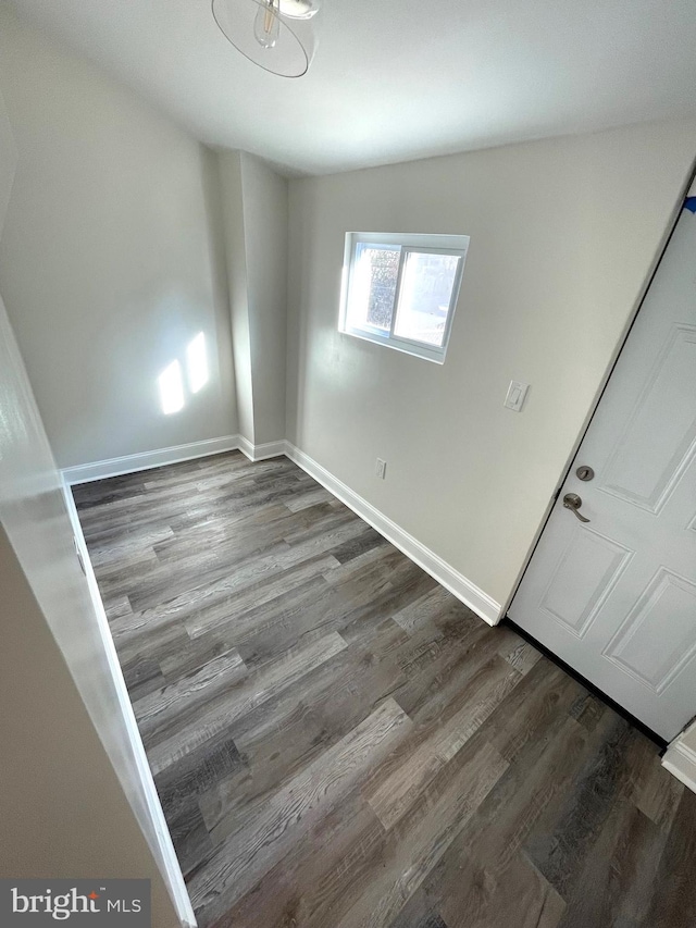 interior space with vaulted ceiling and dark wood-type flooring