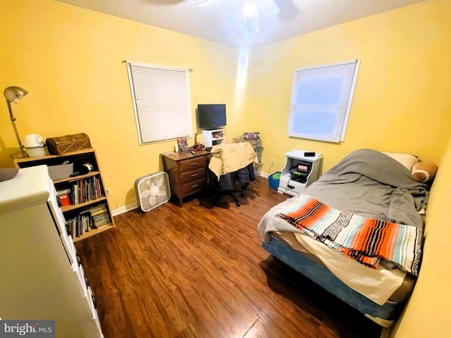 bedroom with ceiling fan and wood-type flooring