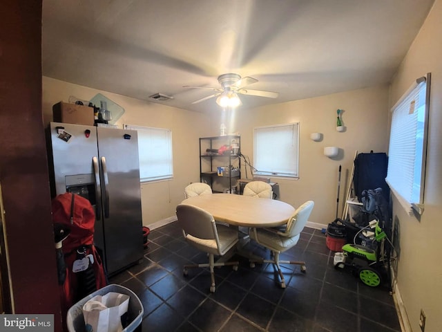 tiled dining area featuring ceiling fan