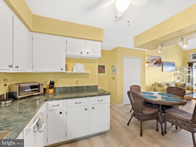 kitchen featuring white cabinets, ceiling fan, rail lighting, and light hardwood / wood-style floors