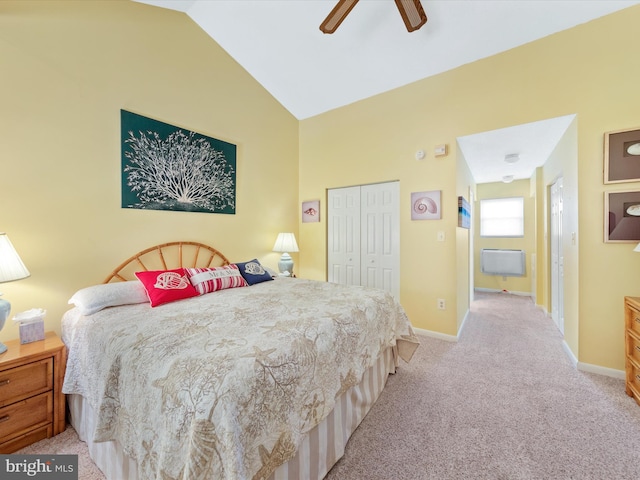 bedroom featuring ceiling fan, a closet, light colored carpet, and vaulted ceiling