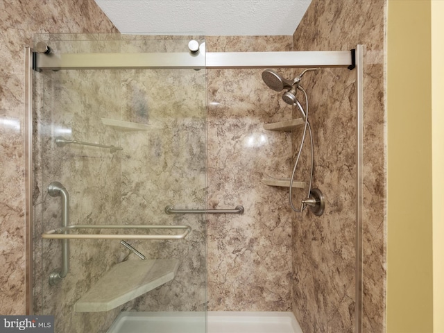 bathroom featuring an enclosed shower and a textured ceiling