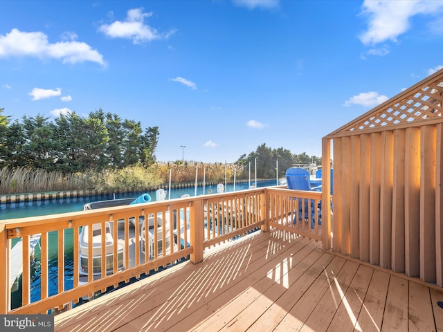 wooden deck with a water view and a trampoline