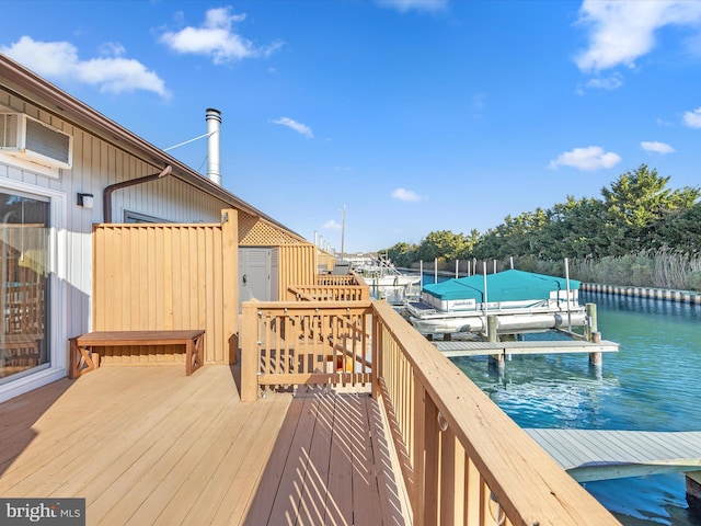 wooden terrace featuring a boat dock and a water view