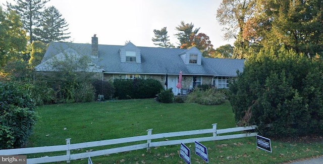 cape cod house featuring a front yard