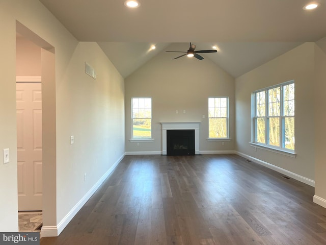 unfurnished living room with lofted ceiling, ceiling fan, and dark wood-type flooring