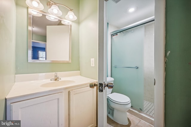 bathroom featuring toilet, vanity, tile patterned floors, and an enclosed shower