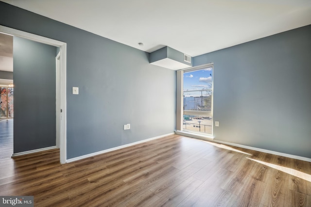 empty room featuring hardwood / wood-style flooring