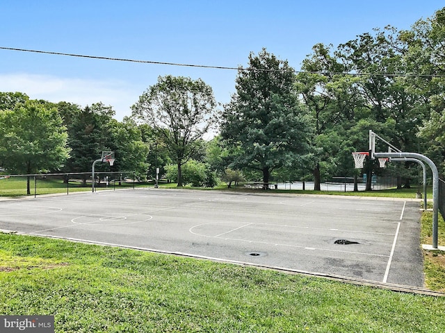 view of sport court with a lawn