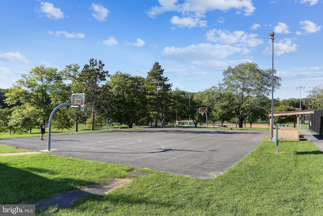 view of basketball court with a lawn