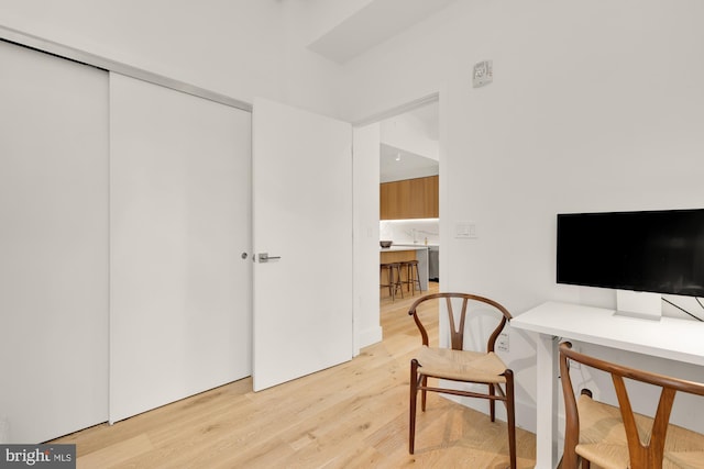 home office with light hardwood / wood-style flooring