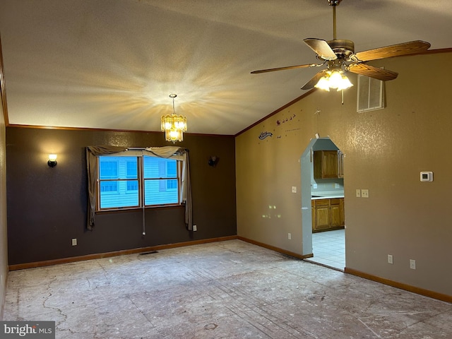 spare room featuring ceiling fan with notable chandelier and ornamental molding