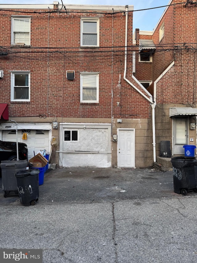 back of property with a garage